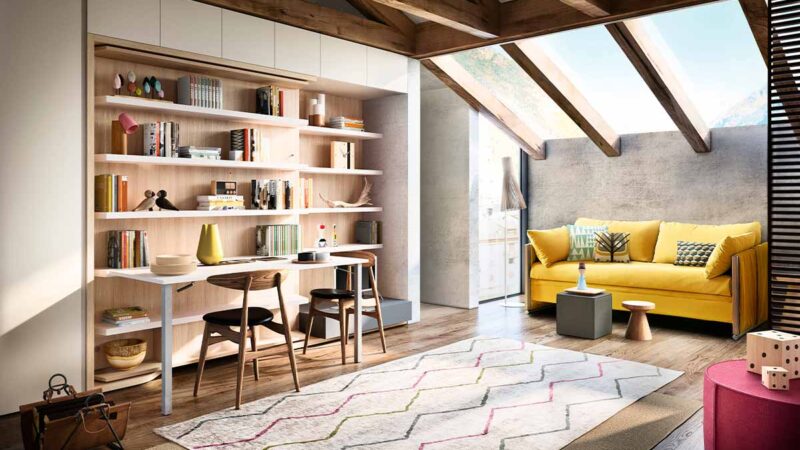 Cama de matrimonio giratoria con gran mesa y librería integradas.